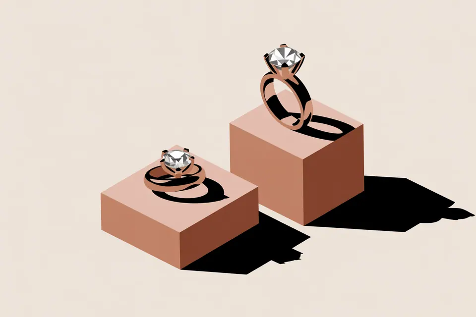 Stone-set rings with contrasting side profiles on rose-colored display blocks.